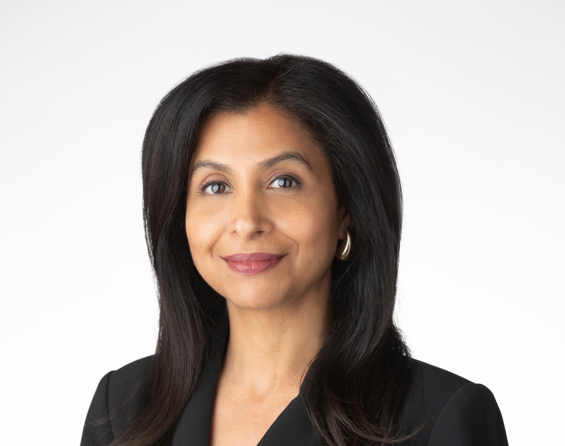 Headshot of Janisha Sabnani in a black suit